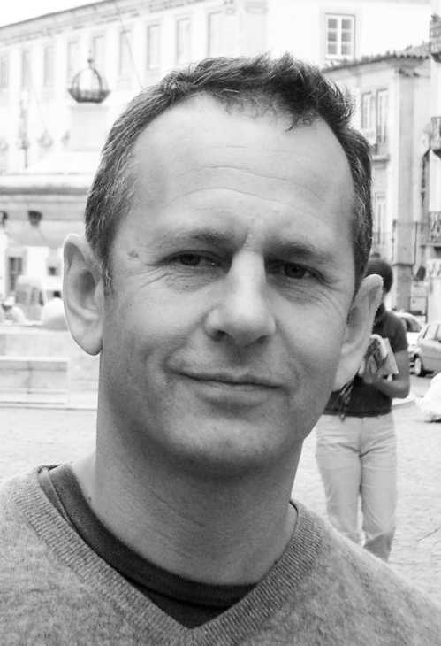 Black and white portrait of Arnaud Montigny, principal of MCH Arnaud Montigny design studio, in an urban setting.