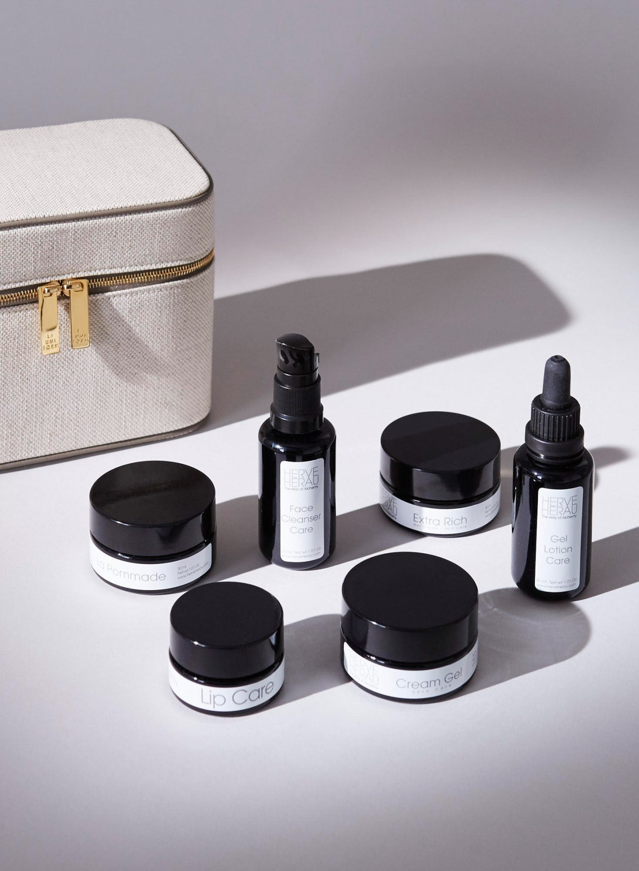 French collaboration vanity case with skincare products including cleanser, lip balm and moisturizer
