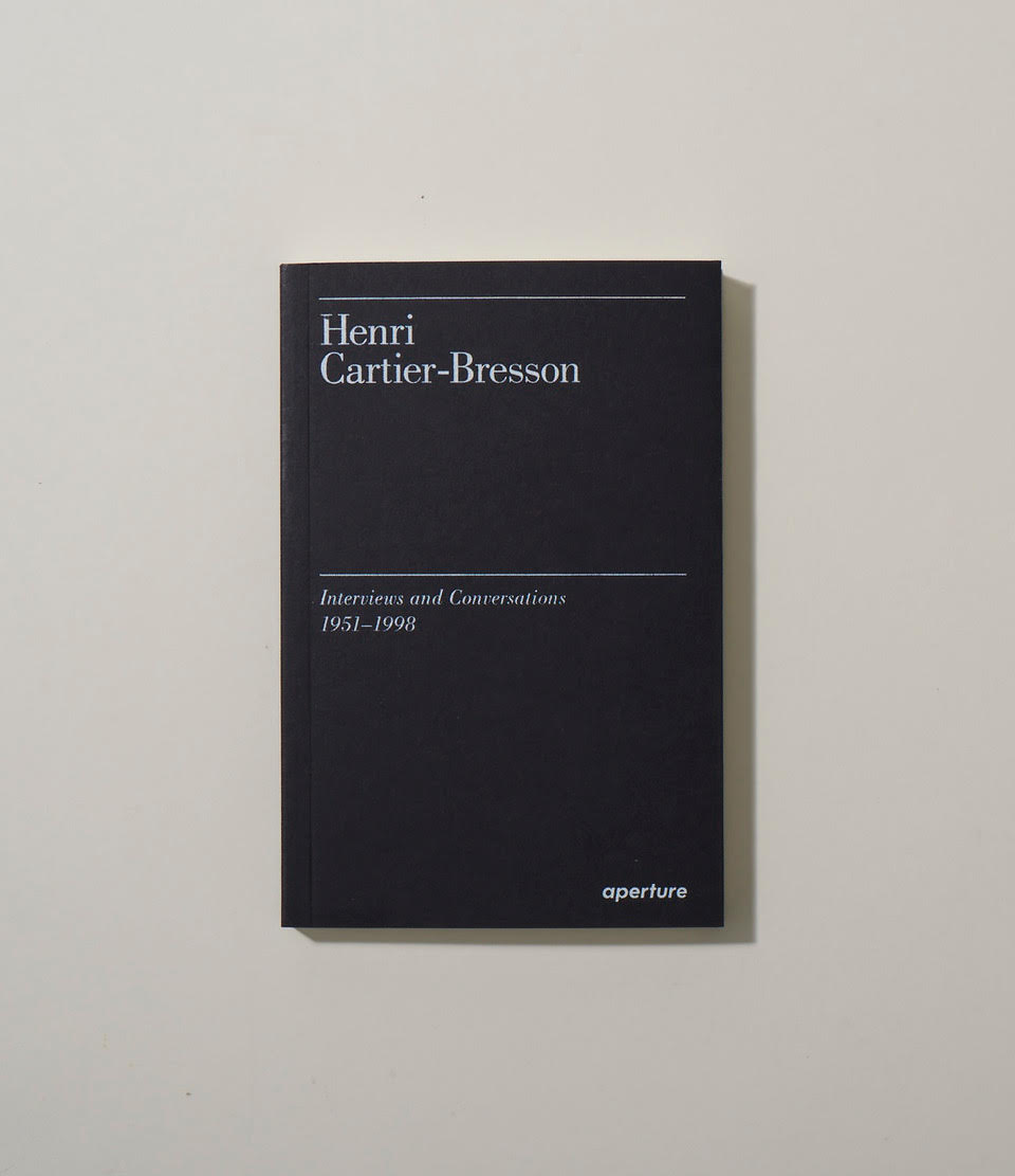 Black book cover with white text reading Henri Cartier-Bresson Interviews and Conversations 1951-1998, published by Aperture.