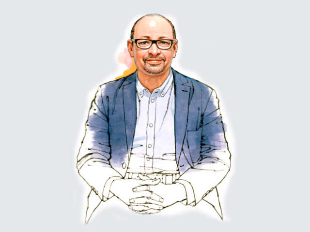 Mark Major, city lighting expert, wearing glasses and blue blazer against neutral background.
