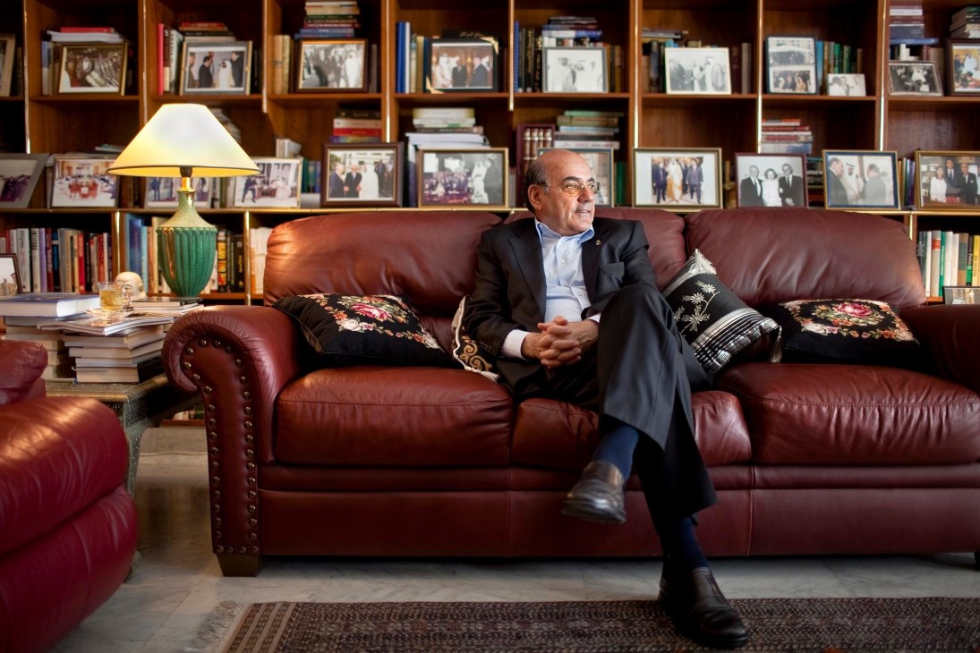Zaki Anwar Nusseibeh, Deputy Chairman for Abu Dhabi Authority for Culture & Heritage, seated on a burgundy leather sofa in a wood-panelled office with framed photographs and books.