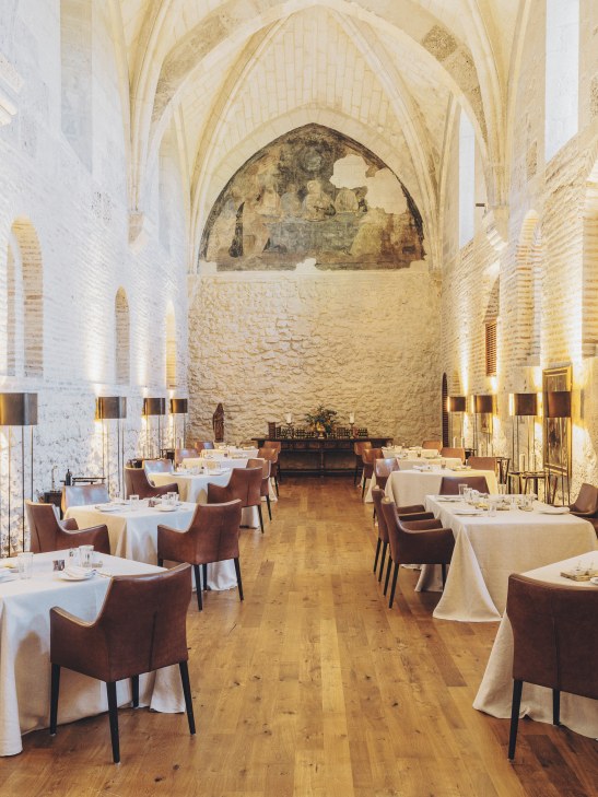 Interior view of Michelin-starred Refectorio restaurant with historic architecture