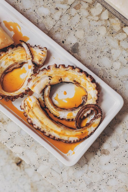 Traditional Galician octopus dish served on a wooden plate at Bar do Porto