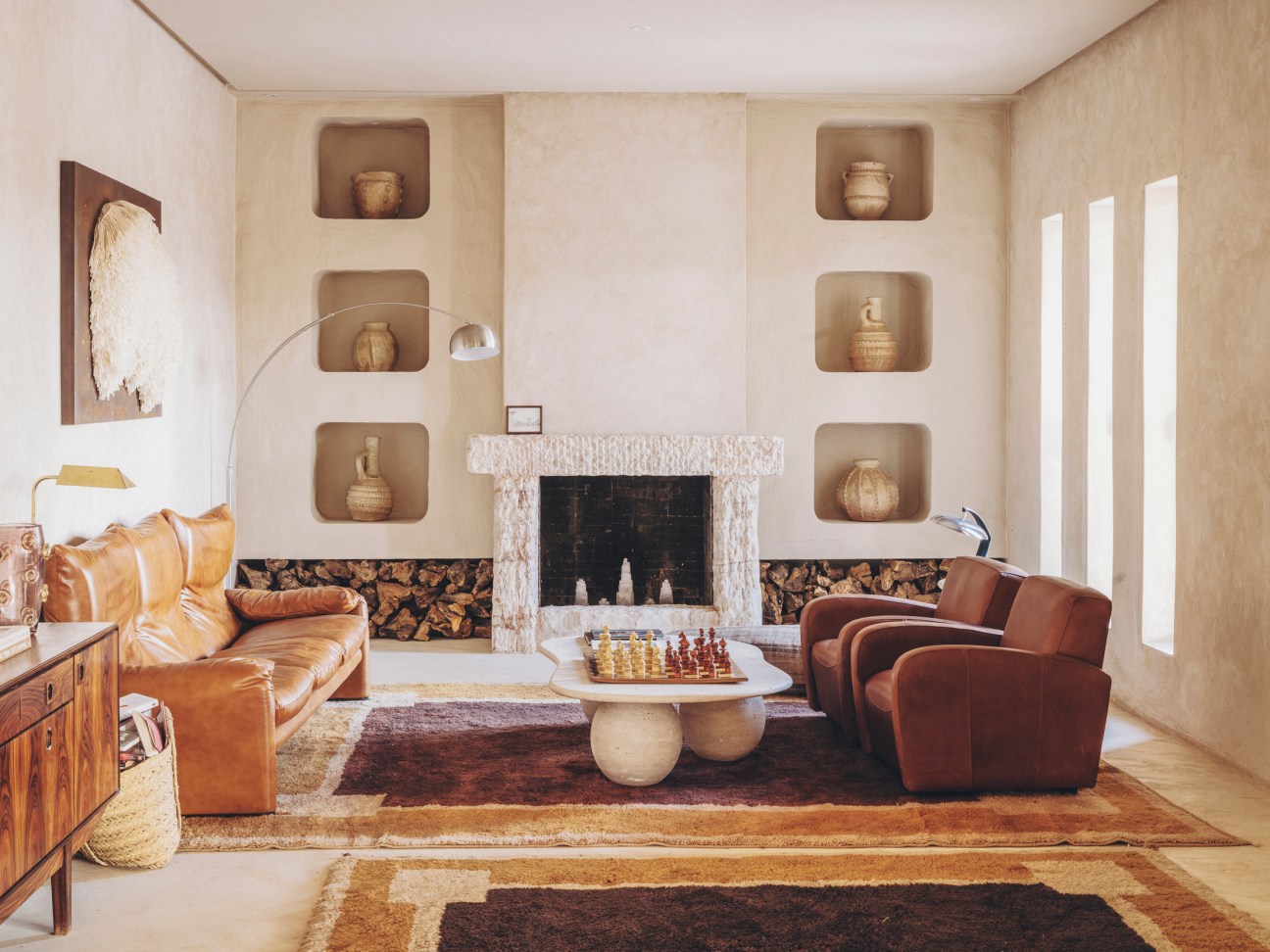 One of several cosy corners with art by Amine El Gotaibi (on left) and sofa, table, and fireplace by Soufiane Zaytoune
