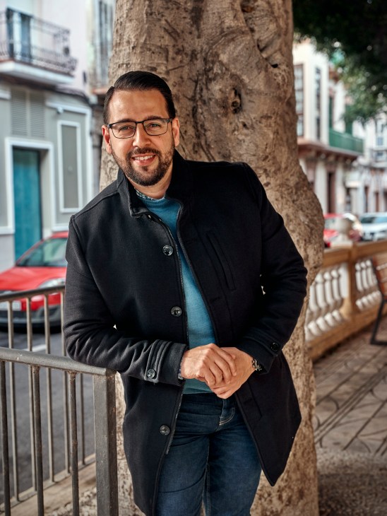 Amin Azmani from Somos Melilla political party standing outdoors wearing glasses and black coat