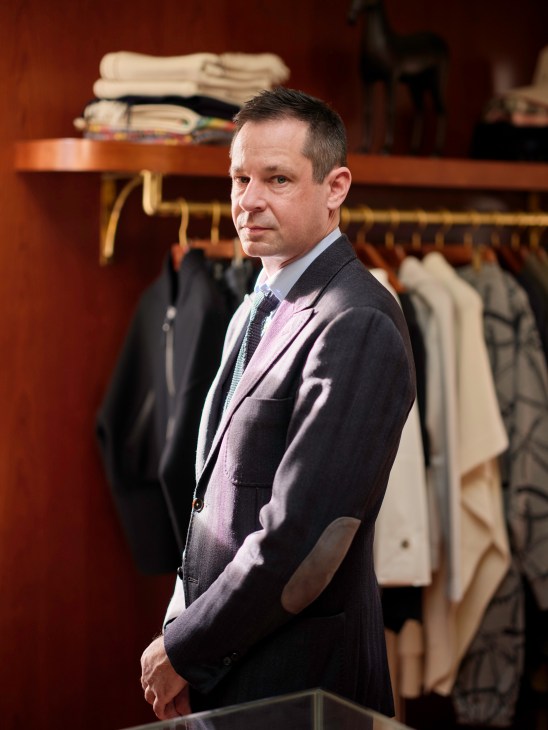 Zachary Kowall standing in the Cuffs boutique surrounded by clothing displays and shelving