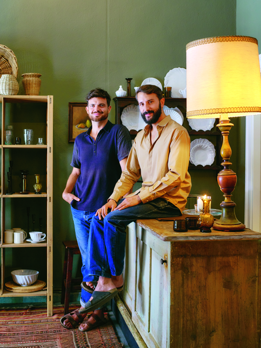 Portrait of Ryan Weimer and Nicola Pozzi, founders of Vicolo Via Mameli, standing in their Milan shop