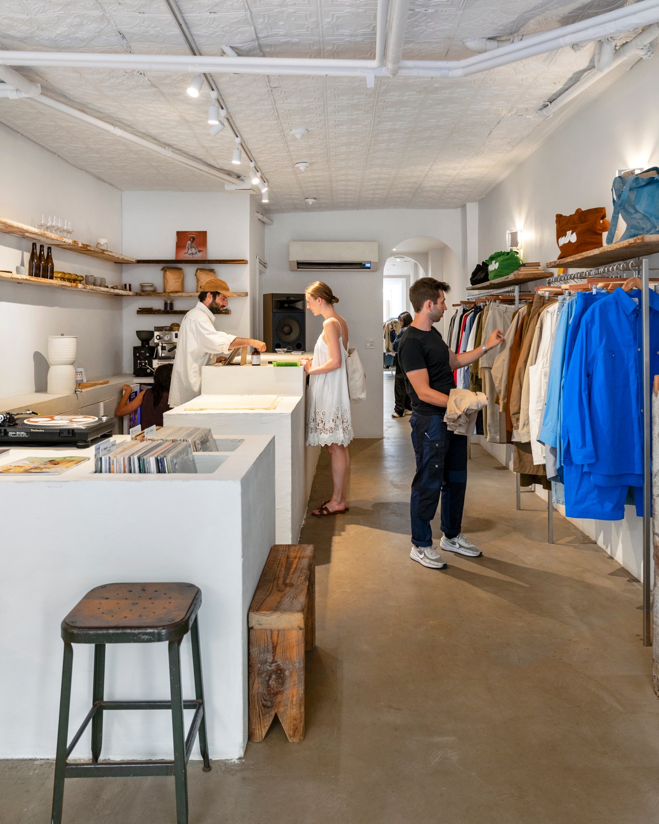 Interior view of Colbo store showing counter area with clothing racks and retail displays