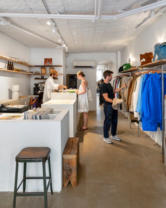 Interior view of Colbo store showing counter area with clothing racks and retail displays