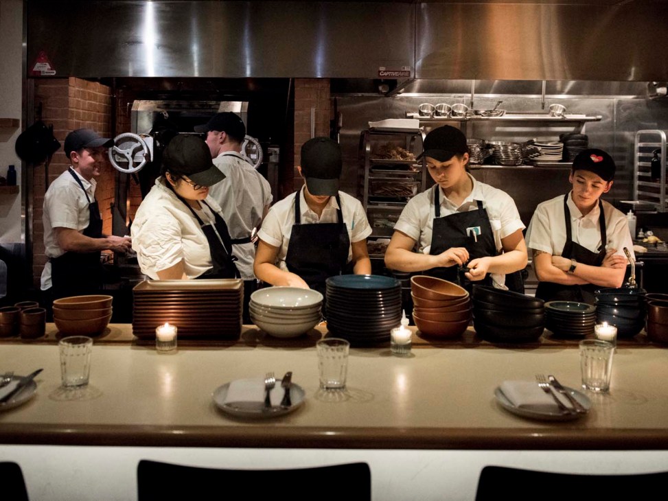 Kitchen staff working at the counter of 232 Bleecker restaurant in Manhattan.