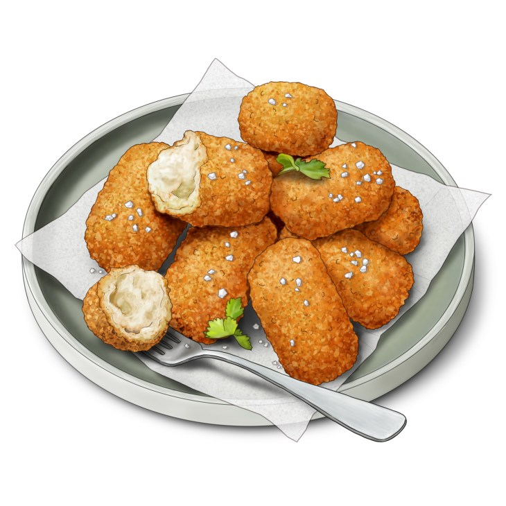 Golden-brown Spanish croquetas on a plate with white salt crystals and green herb garnish
