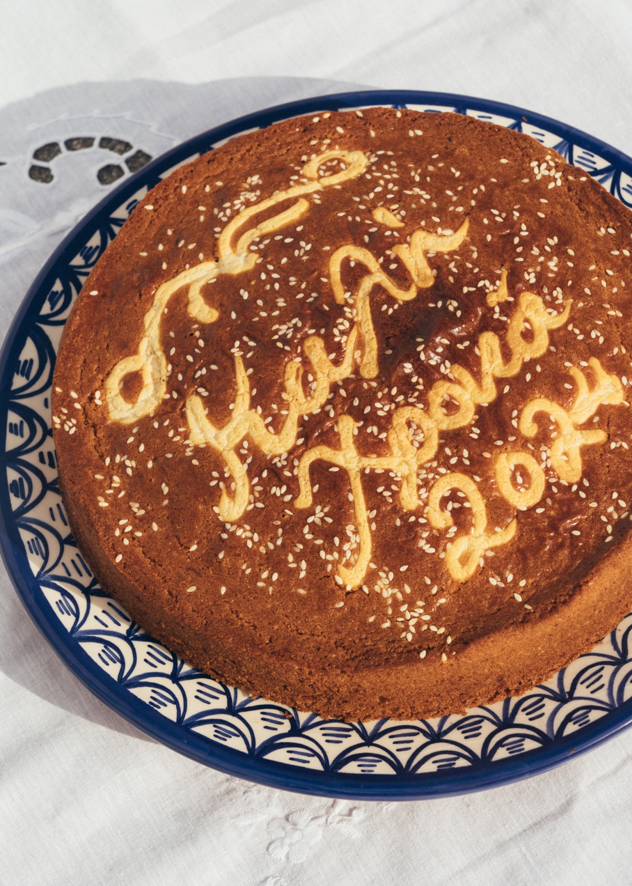 Traditional German Lebkuchen gingerbread cake with decorative yellow icing on blue and white patterned plate