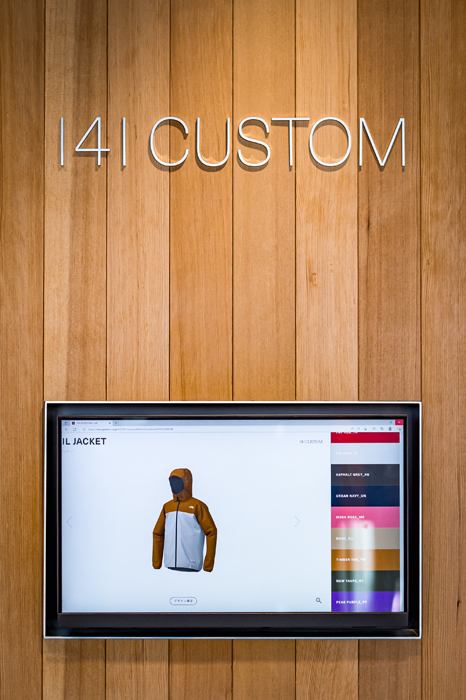 Interior display screen showing North Face jacket customization interface with color options