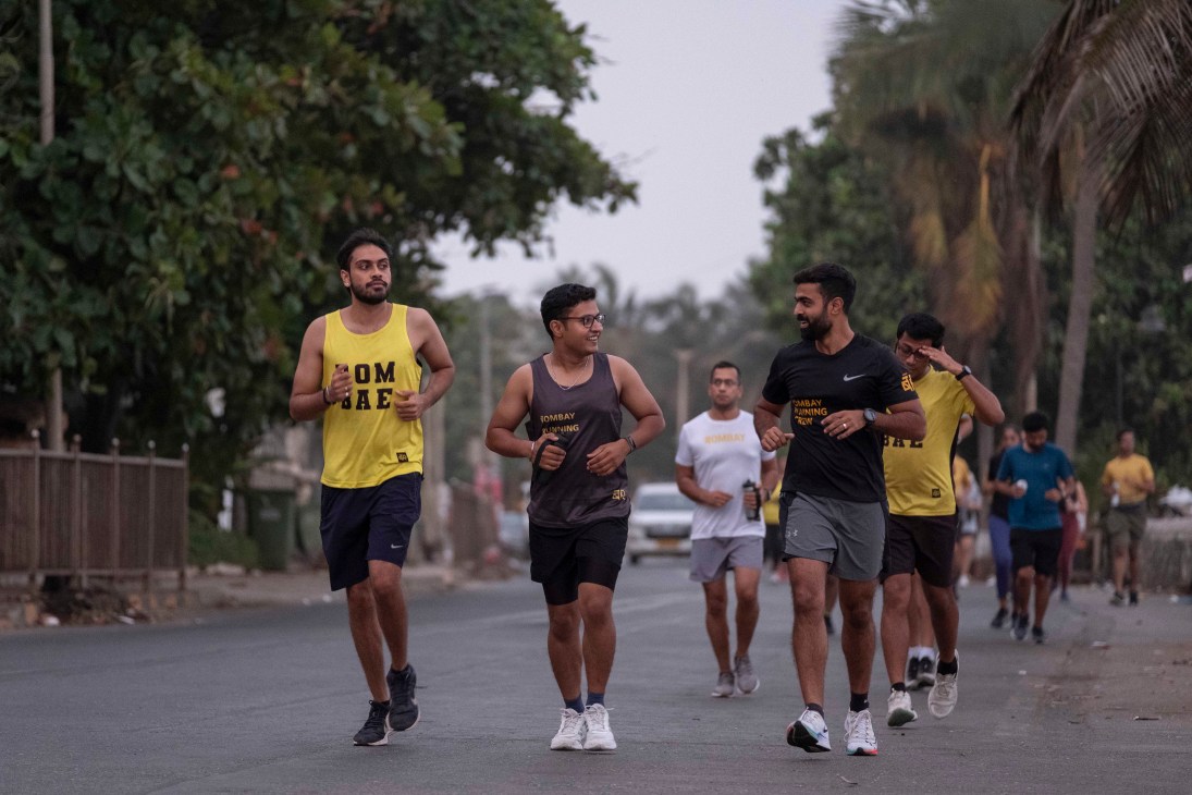 Group of runners from Bombay Running club exercising on the streets of Mumbai at dawn