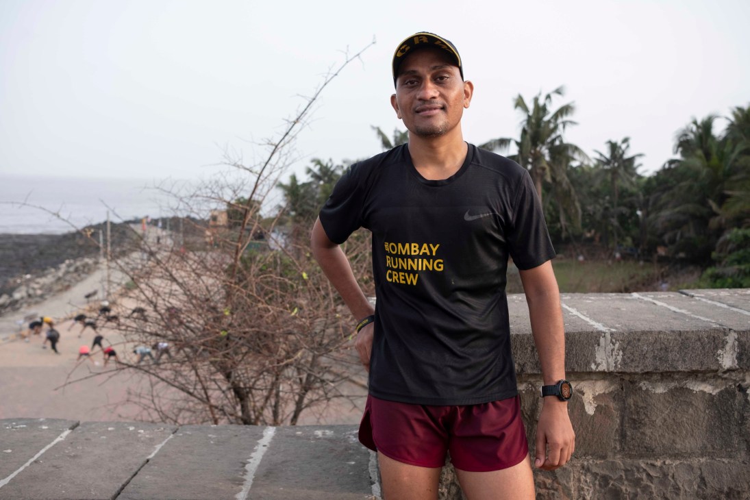 Club member Mukund Vedpathak in black Bombay Running Crew shirt and red shorts standing outdoors