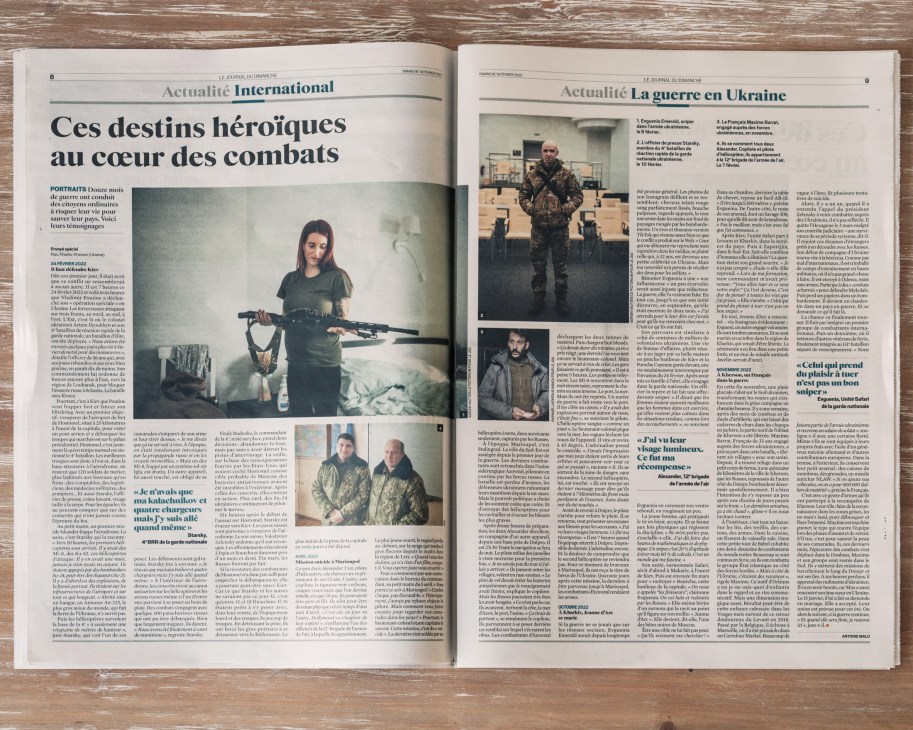 Open pages of Le Journal du Dimanche newspaper showing international news and Ukraine war coverage