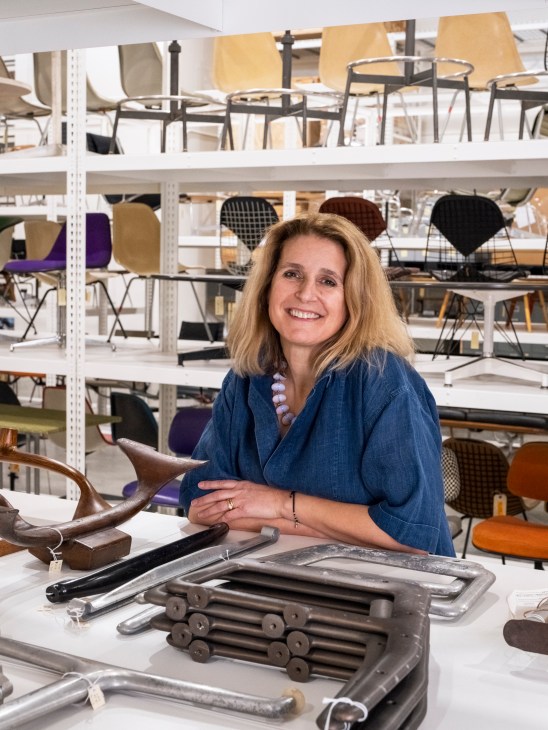 Shelving with categorized Eames prototypes and design materials