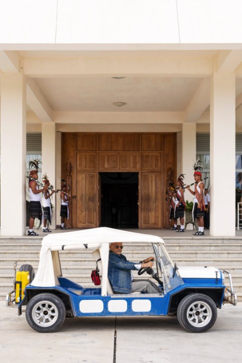 President José Ramos-Horta sits in his bright blue Mini Moke outside the Presidential Palace with traditional guards