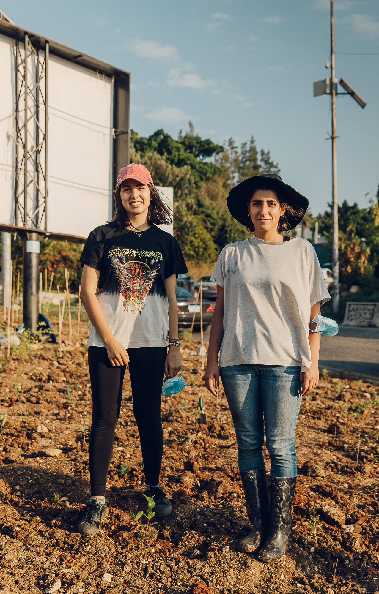 Project members Abiad (on left) and Dana Harakeh standing on dirt ground in casual clothing