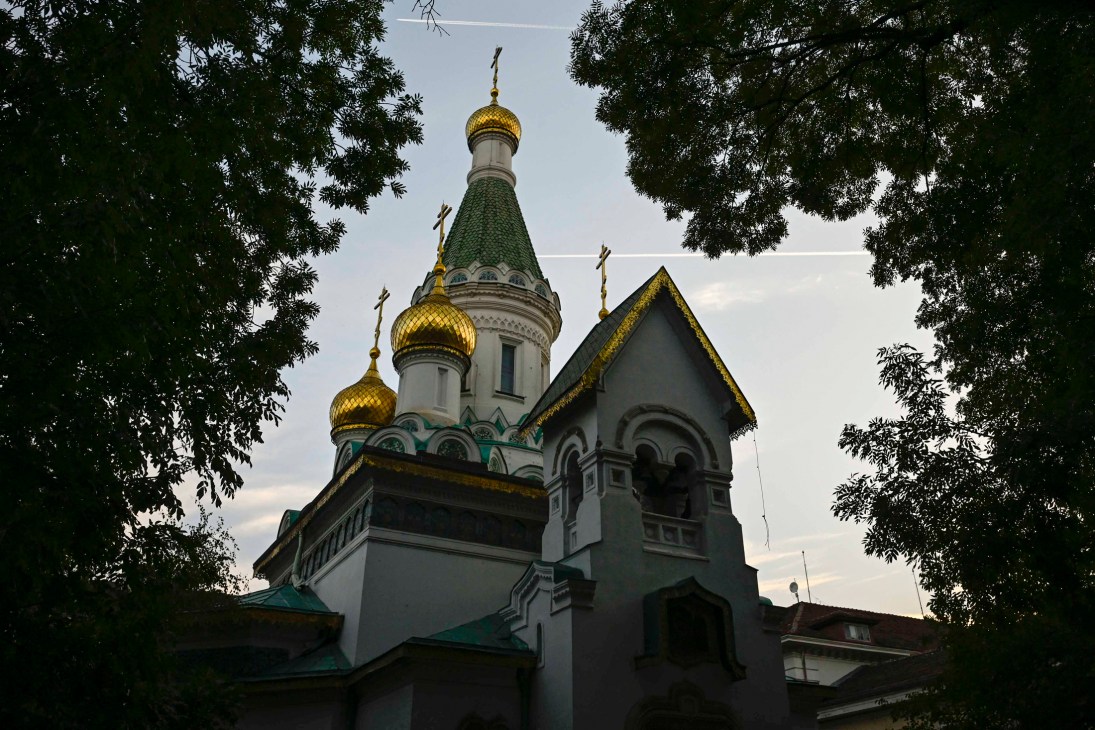 Russian Orthodox church ceremony with ornate religious decorations and clergy
