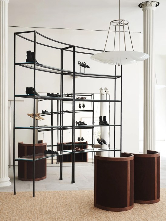 Modern retail interior with black metal shelving displaying shoes and accessories