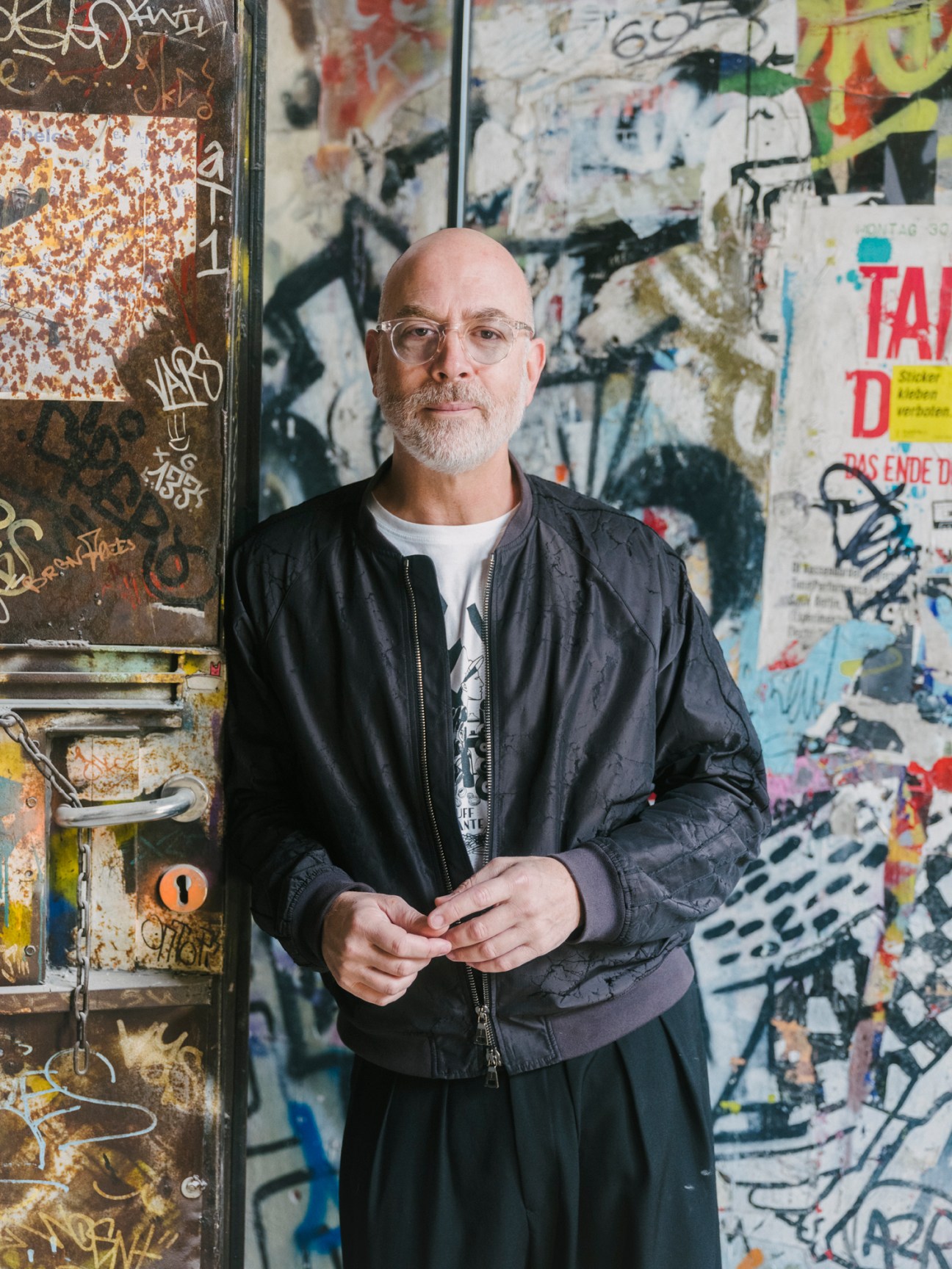 Yoram Roth, executive chairman of Fotografiska, standing in front of graffiti-covered wall