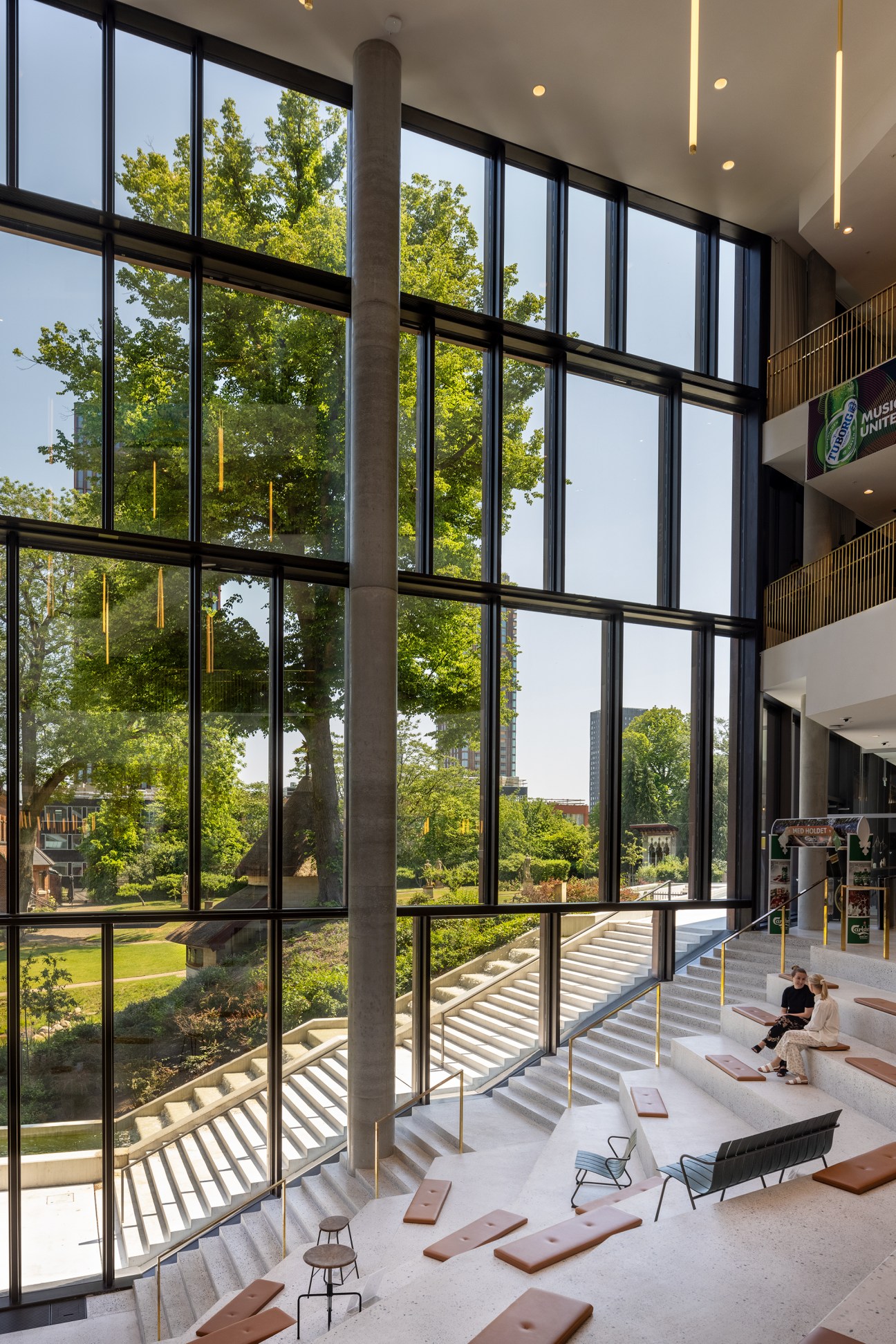 Four-storey glass-panelled atrium with natural light flooding the space