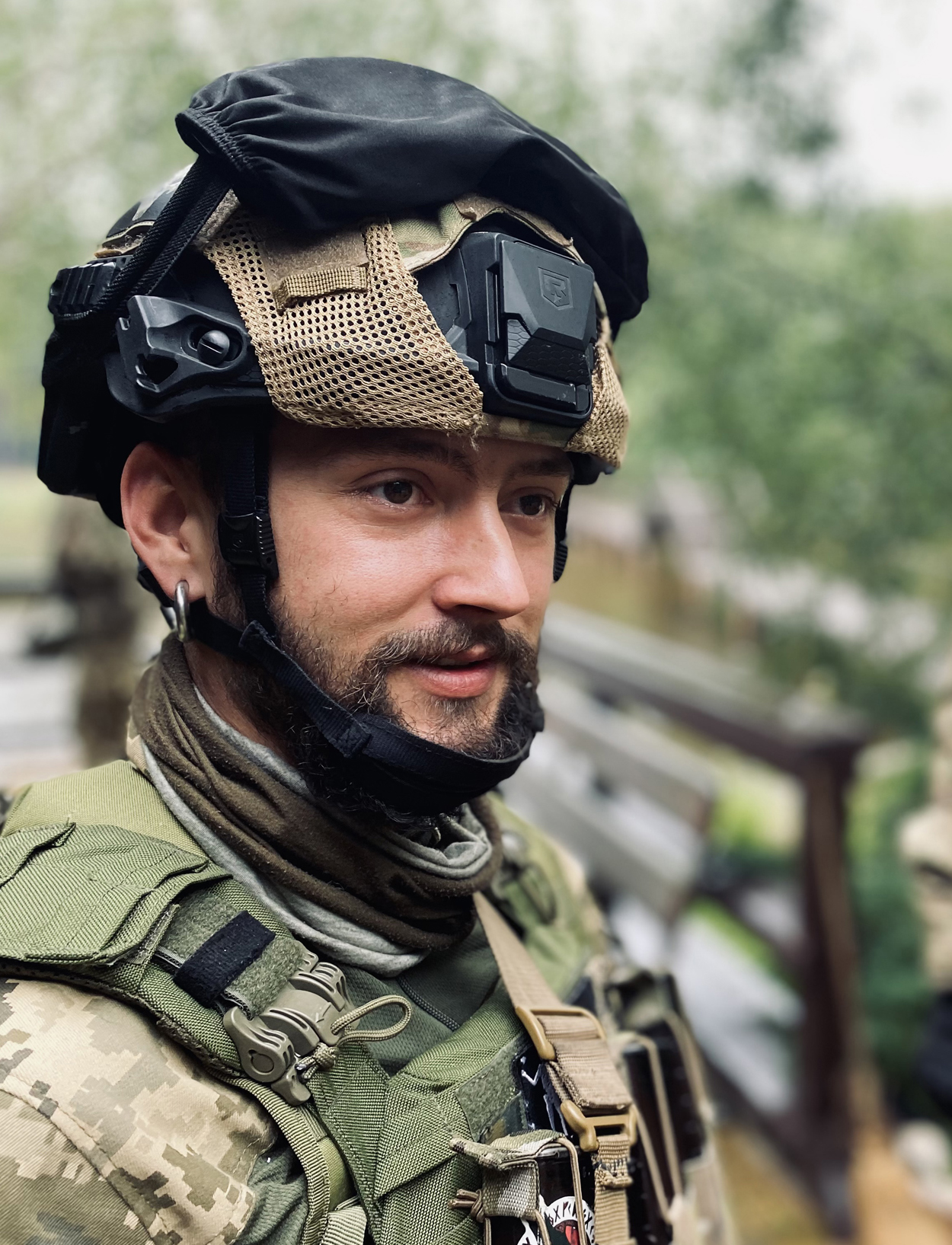 Ukrainian soldier in military fatigues wearing tactical helmet with night vision goggles mounted on front.