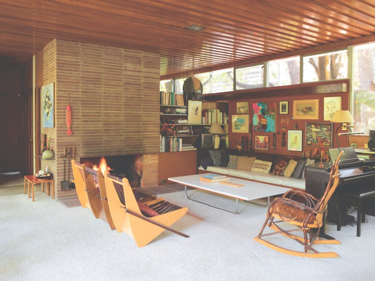 Living room with boarded ceiling and a trio of Neutra’s Boomerang chairs