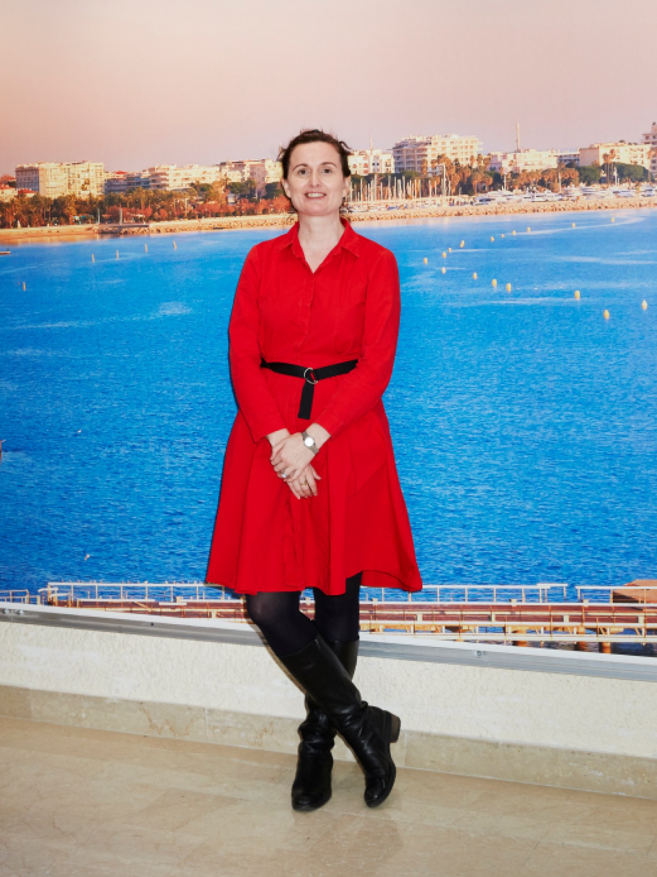 Alice Charles from Arup speaking at Mipim conference in red coat