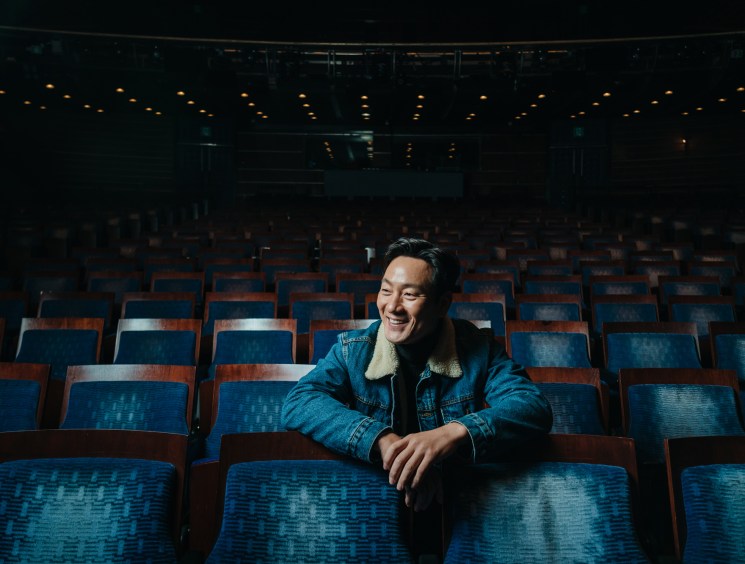 Park Hae-soo sitting and smiling in blue theater seats at Seoul's LG Arts Center