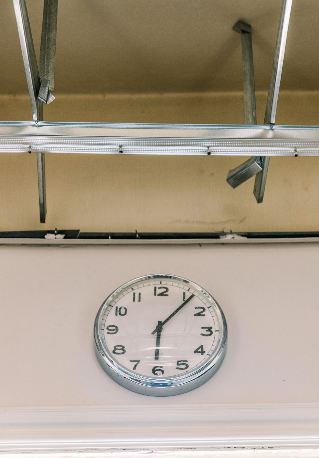 A wall clock showing 18:08, frozen at the exact moment of the Beirut port explosion in Nada Debs' damaged design studio