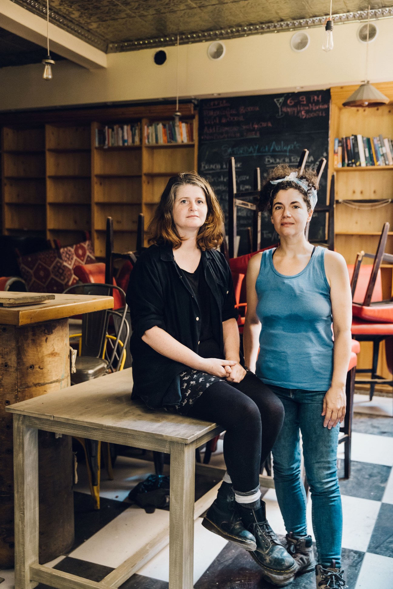 Aaliya's Books co-owners Niamh Fleming-Farrell and Naila Saba standing together in their destroyed bookshop