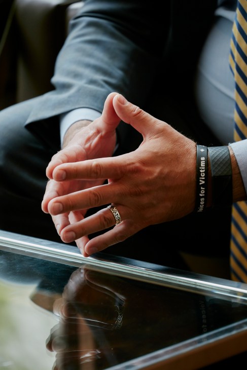 Close-up view of hands and documents on the curved desk of the UN Security Council during a formal session