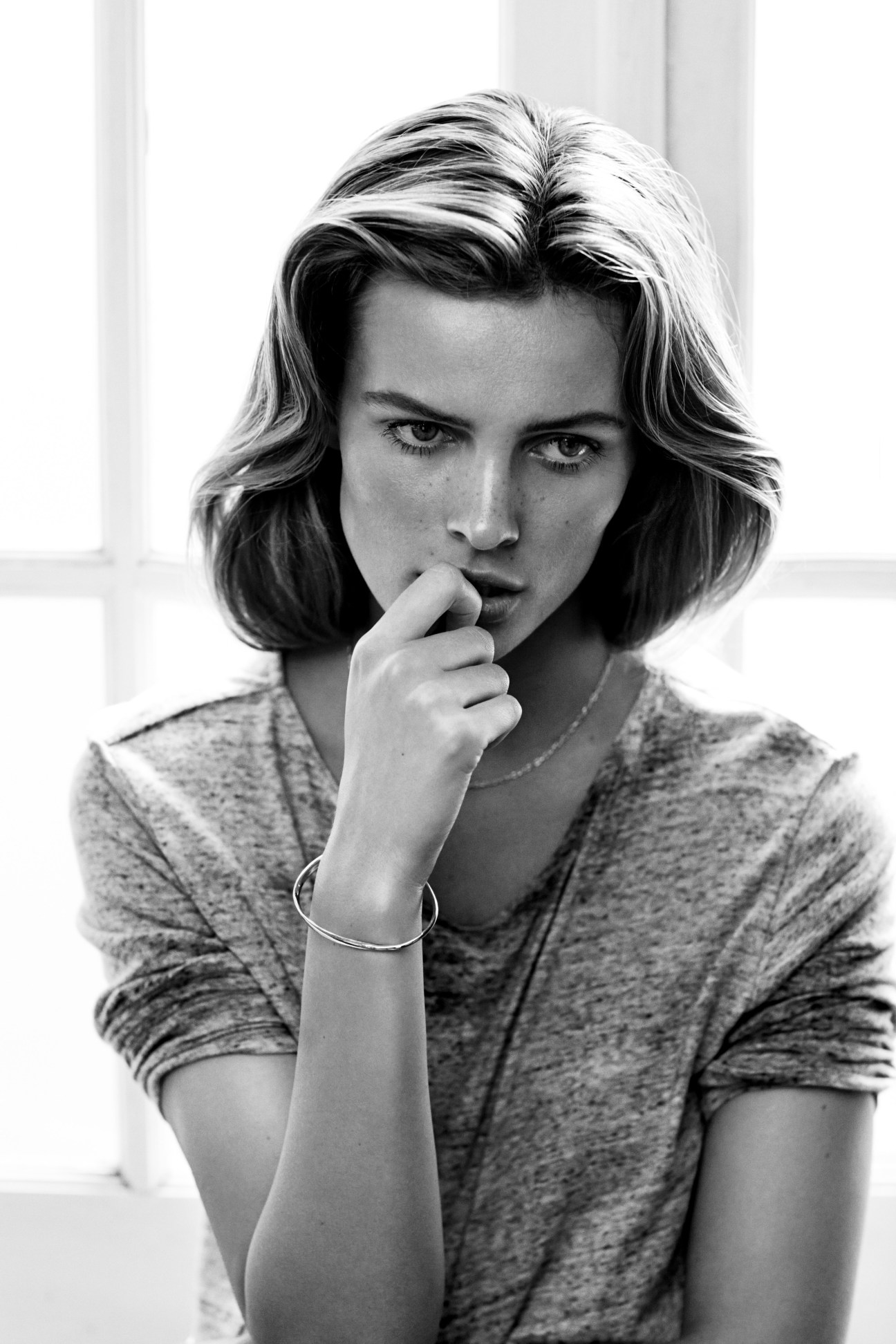 Black and white portrait of model Edita Vilkeviciute in contemplative pose by photographer Lachlan Bailey