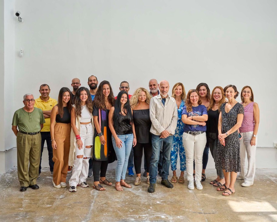 Designer Gregory Gatserelia and his team of young Lebanese designers standing together in a studio space