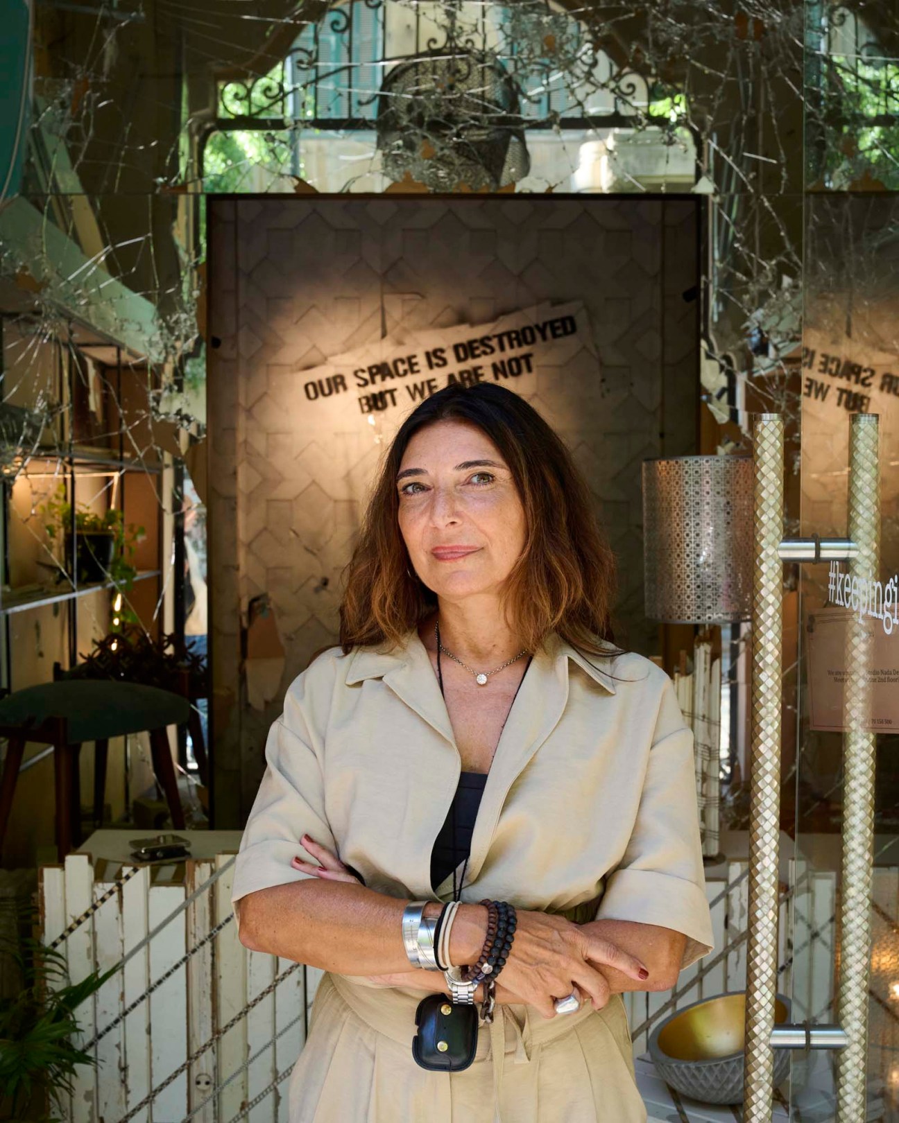 Designer Nada Debs standing in her Beirut studio surrounded by furniture and design pieces