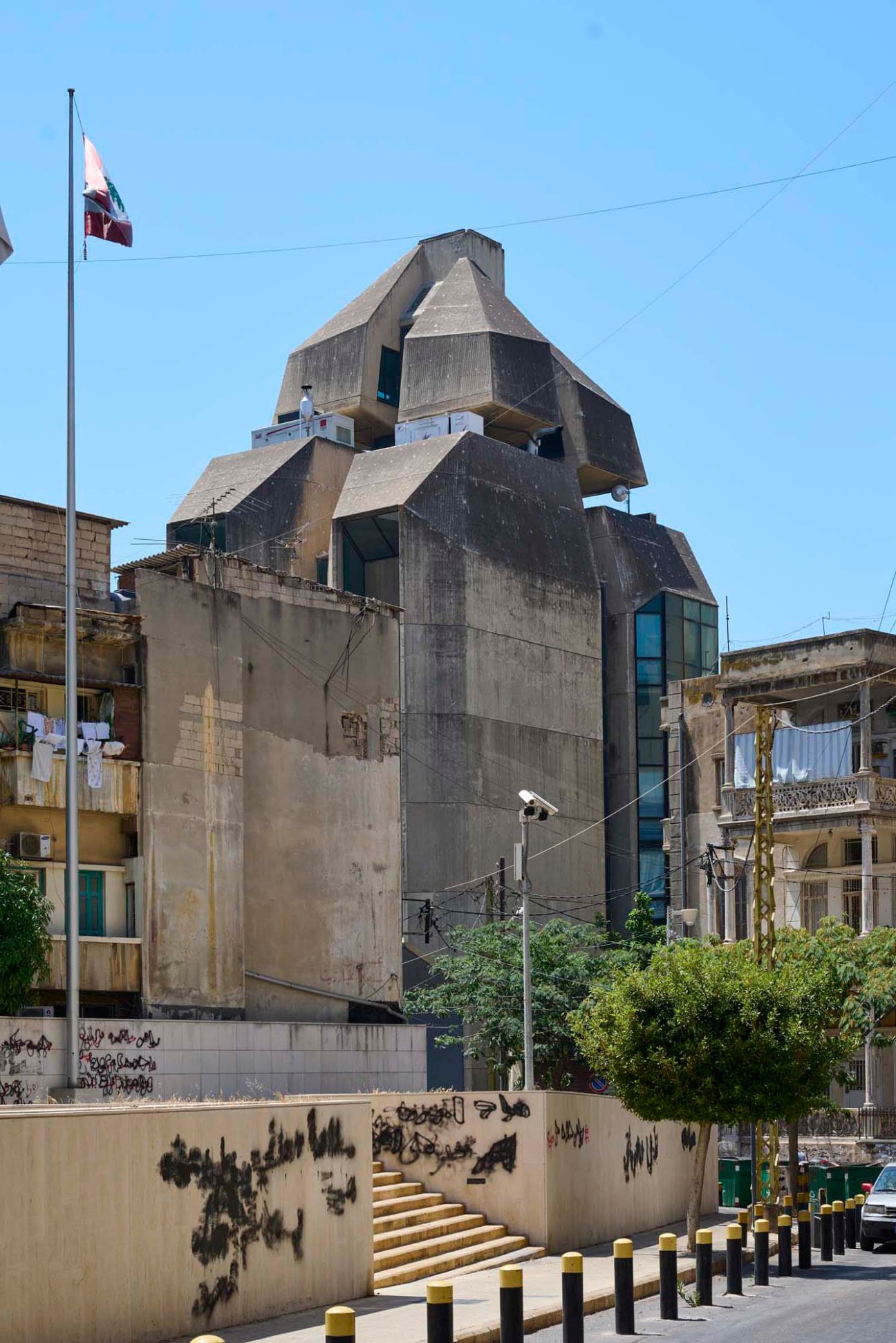 Modernist concrete Interdesign Building by Georges El Khoury in Beirut with stacked geometric forms and weathered facade.