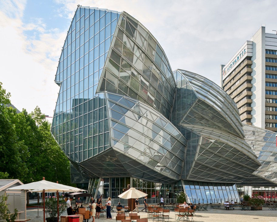 A distinctive curved metallic building facade showing Frank Gehry's signature architectural style