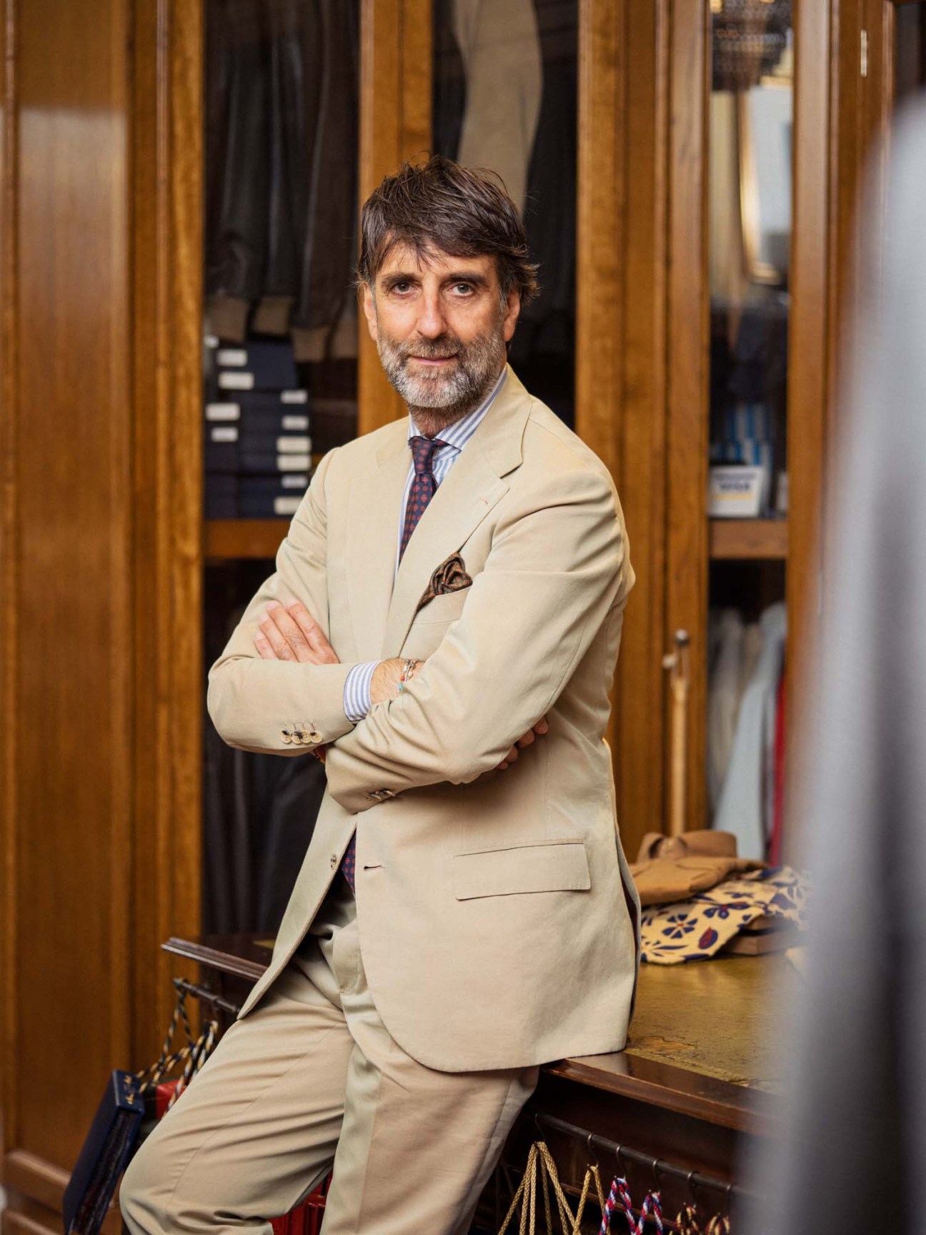Andrea Luparelli, founder of Sartoria Ripense, wearing a tailored beige suit in his Rome atelier.