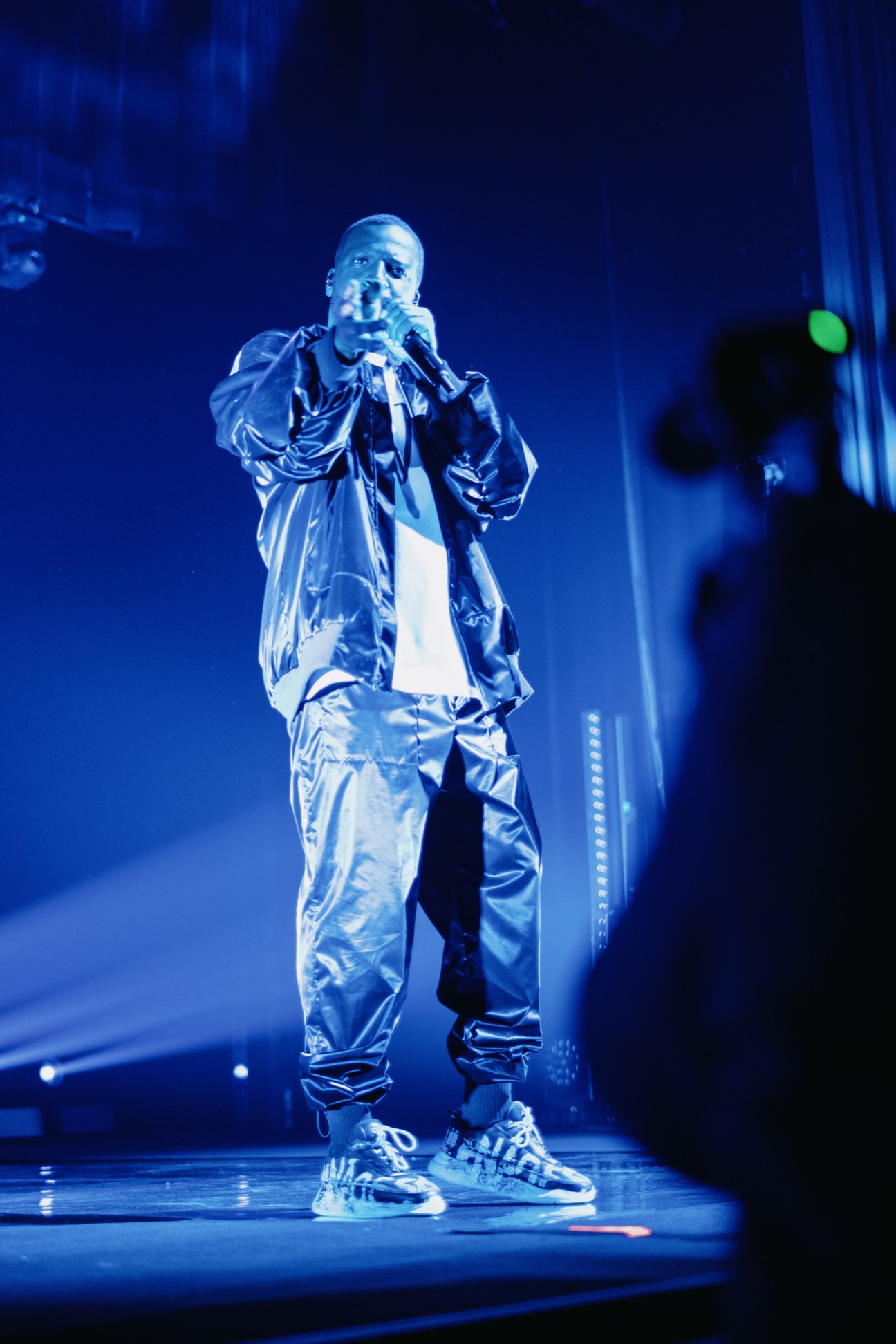 Dino d'Santiago performing on stage with stage lighting