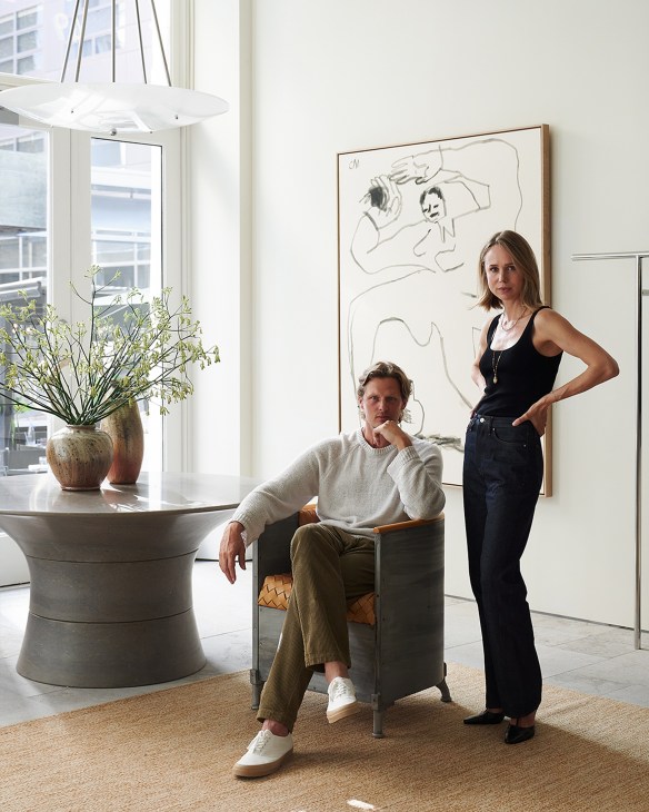 Elin Kling and Karl Lindman standing in their Toteme store interior with modern minimalist design