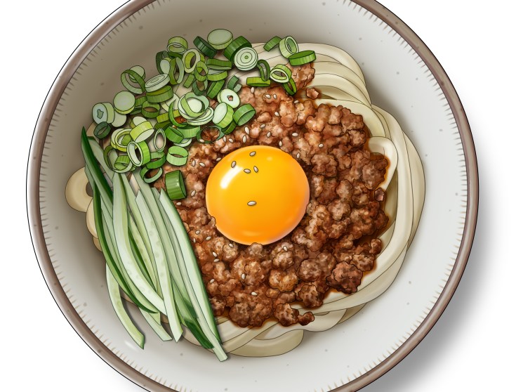 Miso pork udon noodles in a bowl topped with raw egg yolk, sliced green onions and cucumber batons