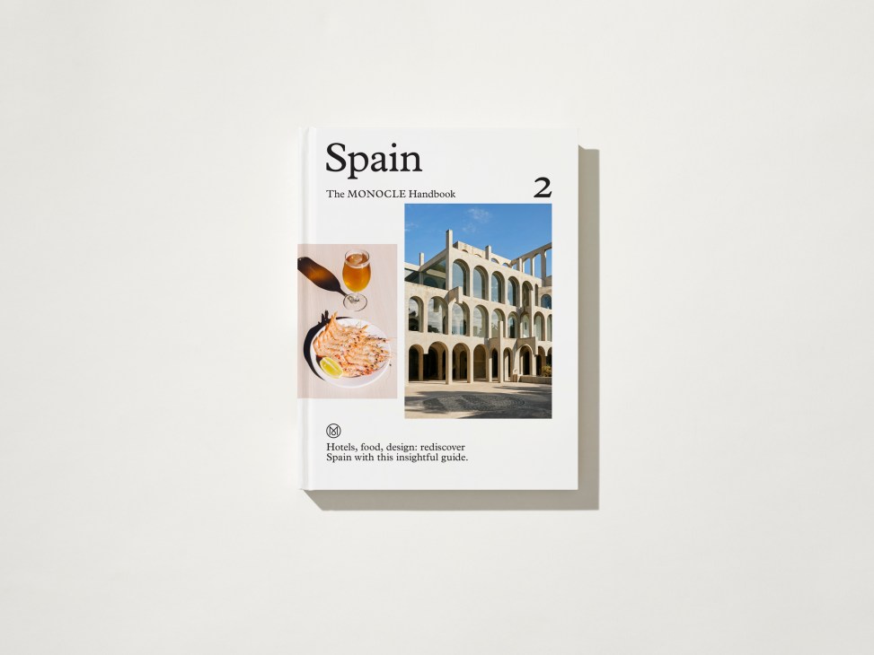 Cover of Spain: The Monocle Handbook showing modern white architecture and Spanish cuisine