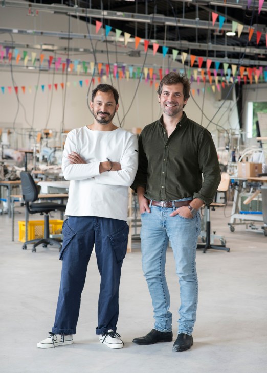 Two men standing together in knitwear factory, Flet on left and Permingeat on right