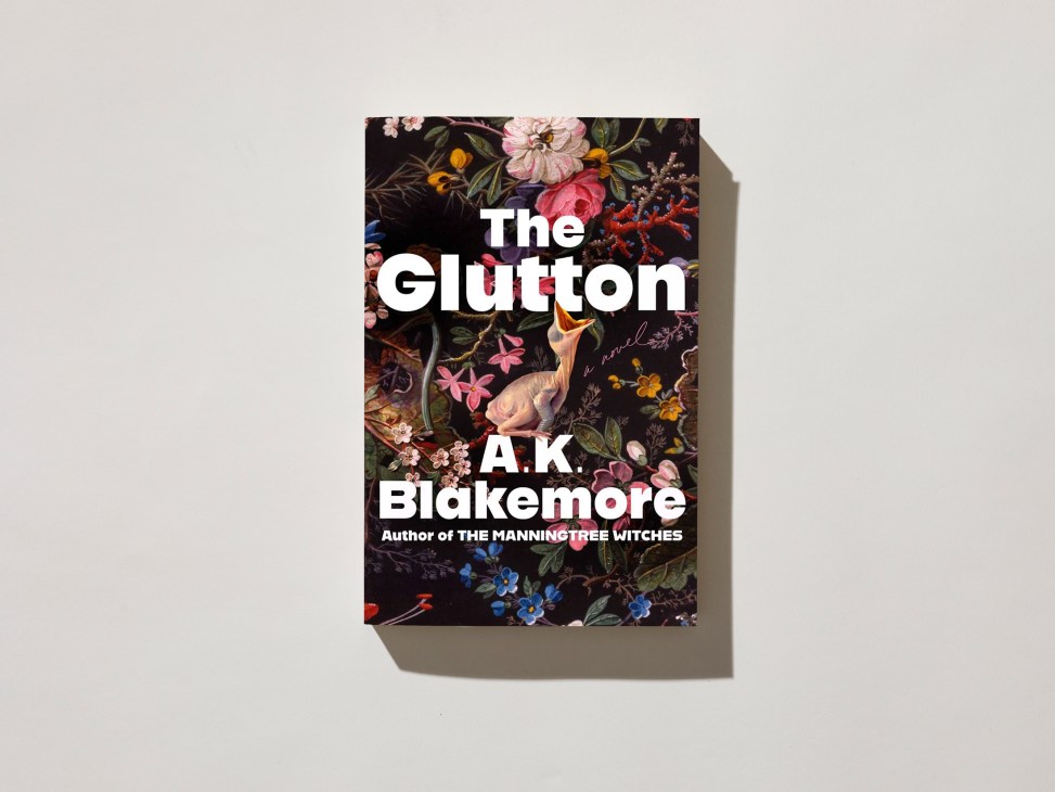 Book cover of 'The Glutton' by A.K. Blakemore featuring ornate floral pattern with colorful flowers and a bird