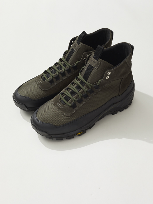Pair of olive green hiking boots with black soles and lacing system