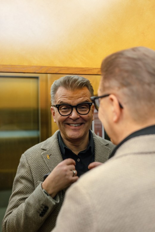 Jari Latvanen, CEO of Stockmann Group, smiling while speaking with someone in an indoor setting