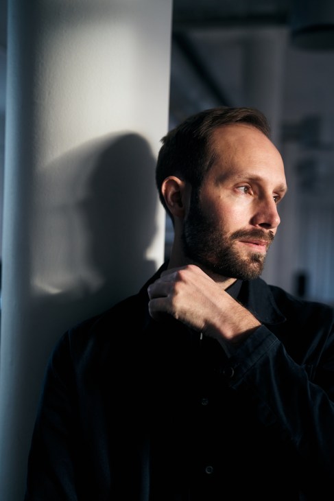 Jakob Dworsky standing in bright minimalist Asket retail space in Stockholm