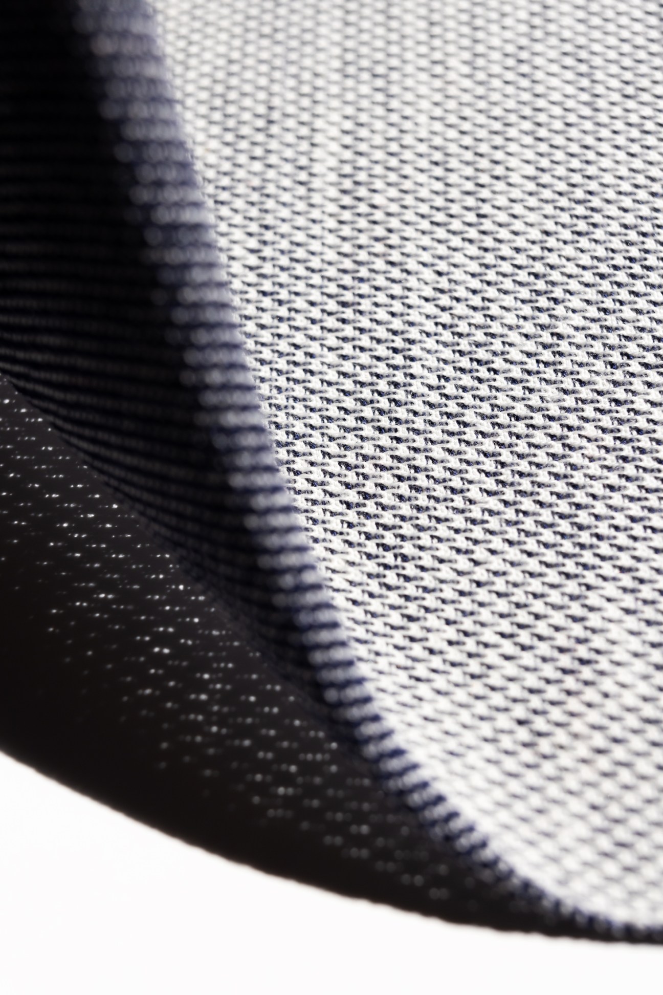 Close-up of woven fabric showing detailed texture and weave pattern of sustainable textile fibers